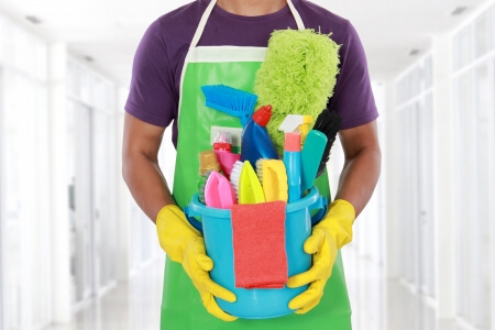 Clean Bathrooms image with man holding tools for cleaning